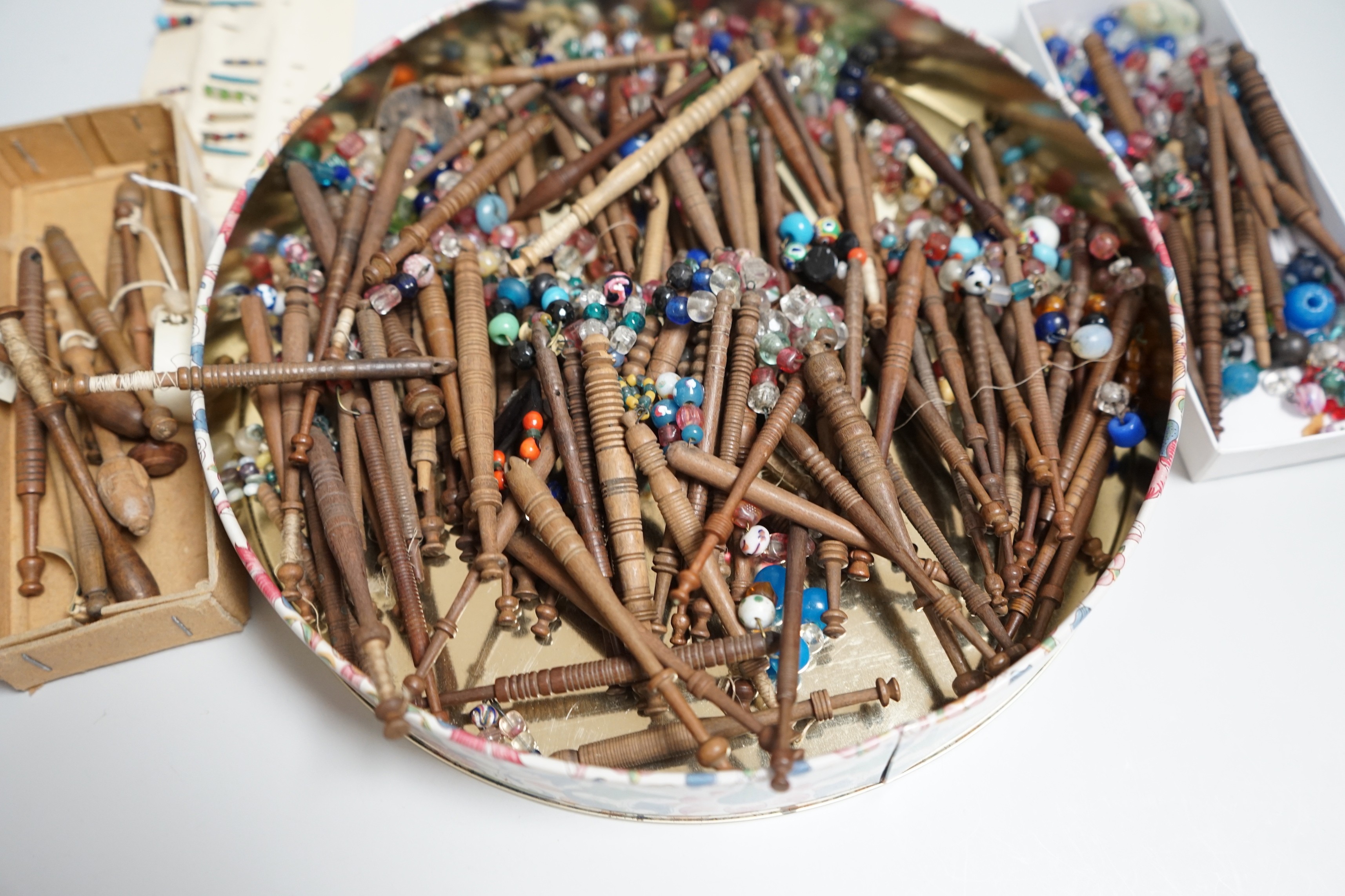 One hundred 19th century turned lace bobbins, plus various broken bobbins and spare beading